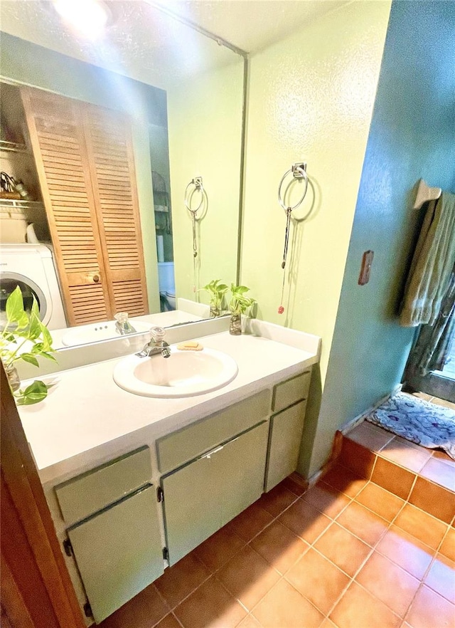 4042 S Lockwood Ridge Rd, Sarasota, FL 34231 - bathroom with washer / dryer, vanity, tile patterned floors, and a closet