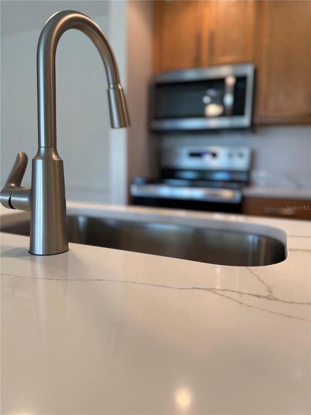 4037 Crockers Lake Blvd Unit 24, Sarasota, FL 34238 - kitchen view of stainless steel microwave and a sink