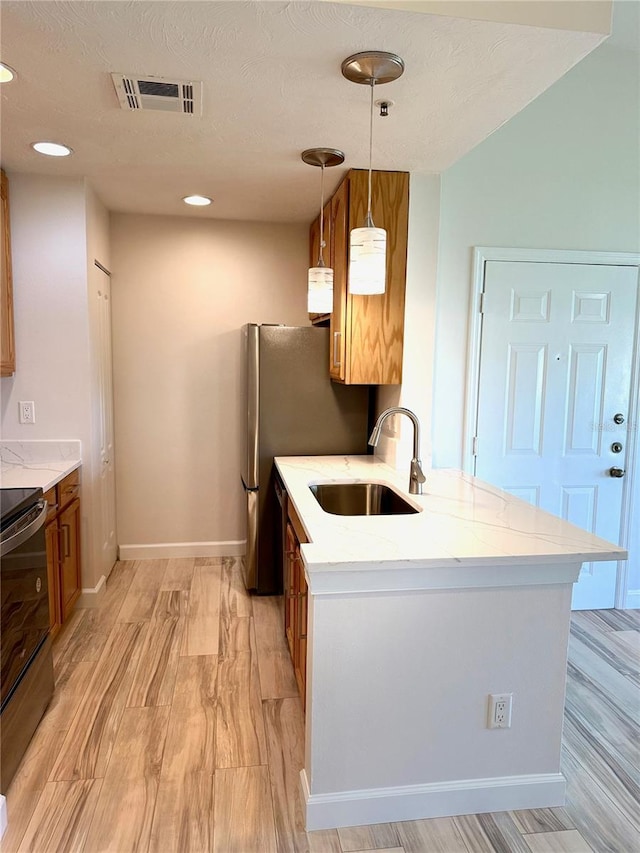 4037 Crockers Lake Blvd Unit 24, Sarasota, FL 34238 - kitchen with a sink, electric range, brown cabinets, baseboards, and light stone counters