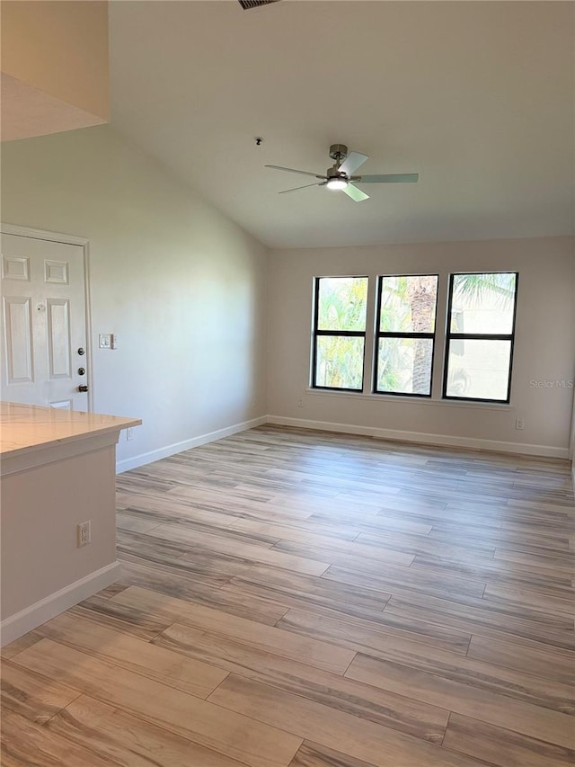 4037 Crockers Lake Blvd Unit 24, Sarasota, FL 34238 - unfurnished room with ceiling fan, light wood-style flooring, baseboards, and vaulted ceiling