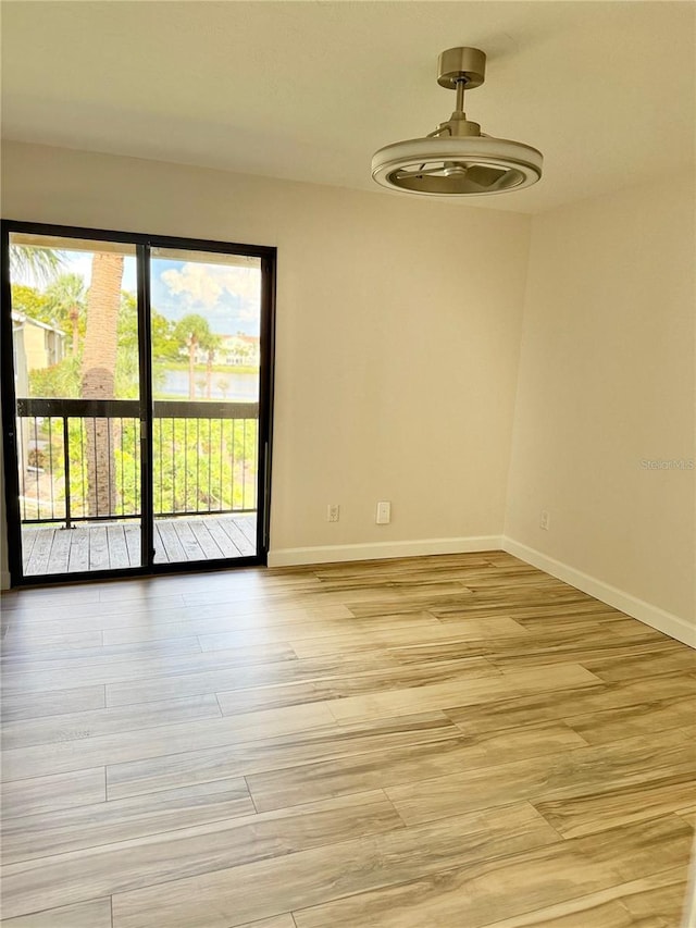 4037 Crockers Lake Blvd Unit 24, Sarasota, FL 34238 - unfurnished room with baseboards and light wood-style flooring
