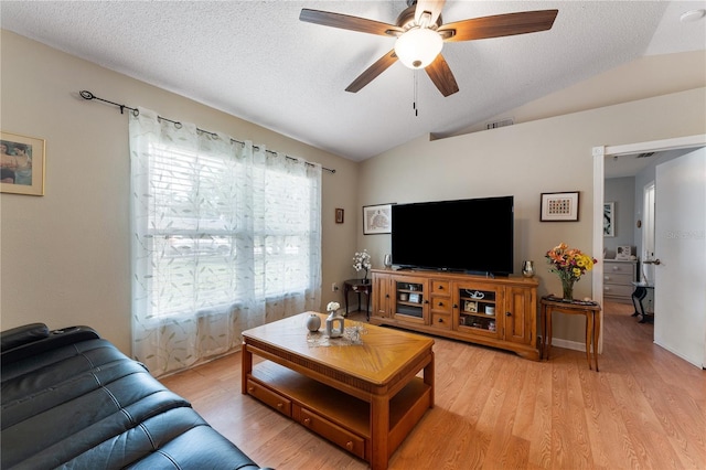 712 68th Ave W, Bradenton, FL 34207 - living room with vaulted ceiling, light wood-style floors, ceiling fan, and a textured ceiling