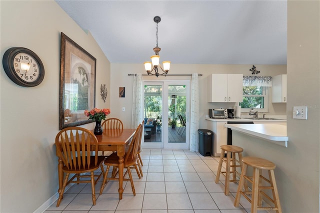 712 68th Ave W, Bradenton, FL 34207 - dining space featuring a chandelier and light tile patterned flooring