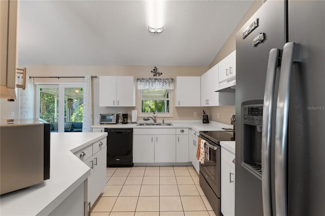 712 68th Ave W, Bradenton, FL 34207 - kitchen with stainless steel appliances, under cabinet range hood, a sink, light countertops, and white cabinetry