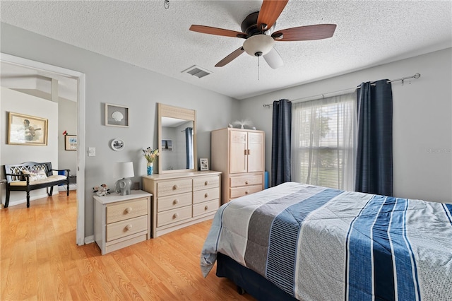 712 68th Ave W, Bradenton, FL 34207 - bedroom featuring a textured ceiling, light wood finished floors, and ceiling fan