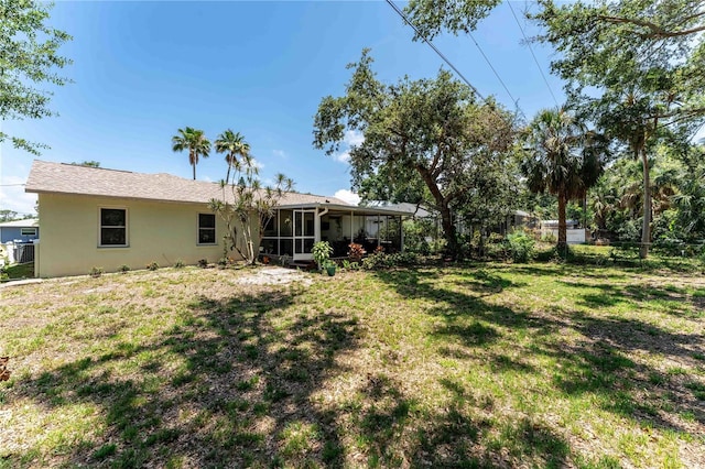 712 68th Ave W, Bradenton, FL 34207 - rear view of property with a sunroom and stucco siding