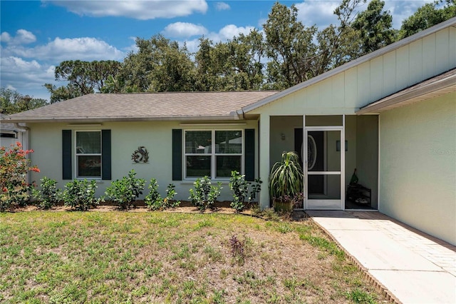712 68th Ave W, Bradenton, FL 34207 - view of front of property featuring stucco siding, a front lawn, and a shingled roof
