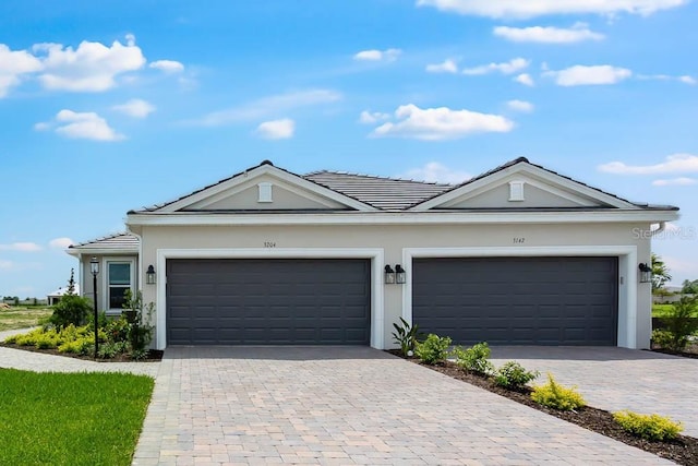 3204 Torta Ct, Bradenton, FL 34211 - single story home featuring decorative driveway, stucco siding, a tiled roof, and a garage