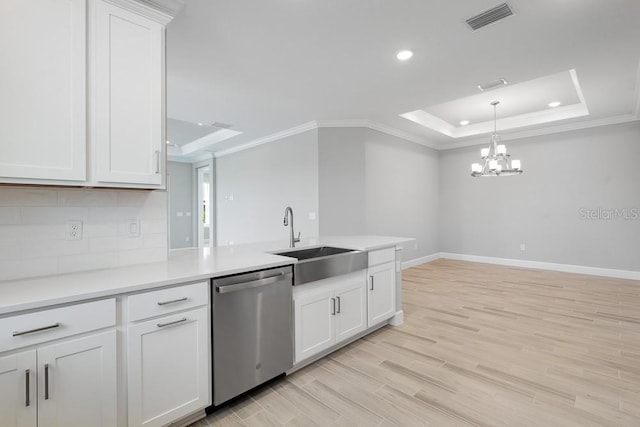 3204 Torta Ct, Bradenton, FL 34211 - kitchen featuring stainless steel dishwasher, ornamental molding, a tray ceiling, white cabinetry, and light countertops