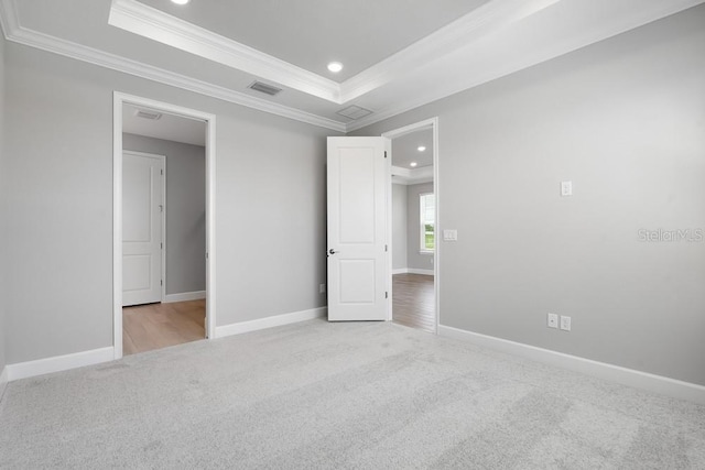 3204 Torta Ct, Bradenton, FL 34211 - unfurnished bedroom with light colored carpet, crown molding, a tray ceiling, and recessed lighting
