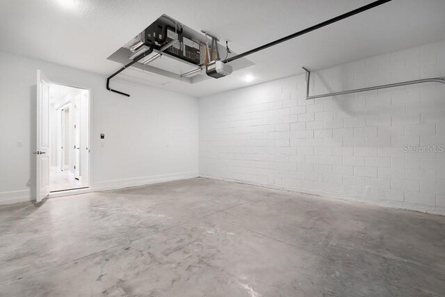 3204 Torta Ct, Bradenton, FL 34211 - garage featuring a garage door opener and concrete block wall