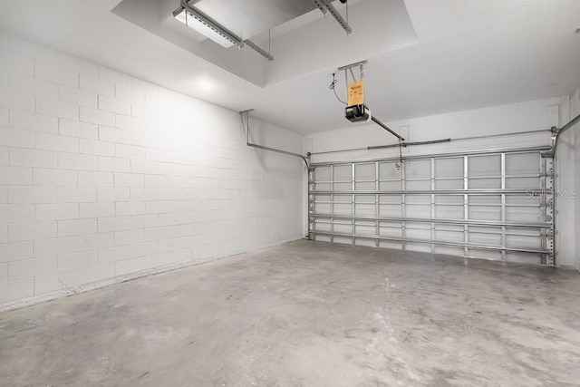 3204 Torta Ct, Bradenton, FL 34211 - garage featuring a garage door opener and concrete block wall