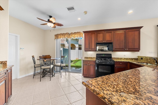 138 Tiziano Way N, Venice, FL 34275 - kitchen with black appliances, a ceiling fan, a sink, dark stone counters, and light tile patterned flooring