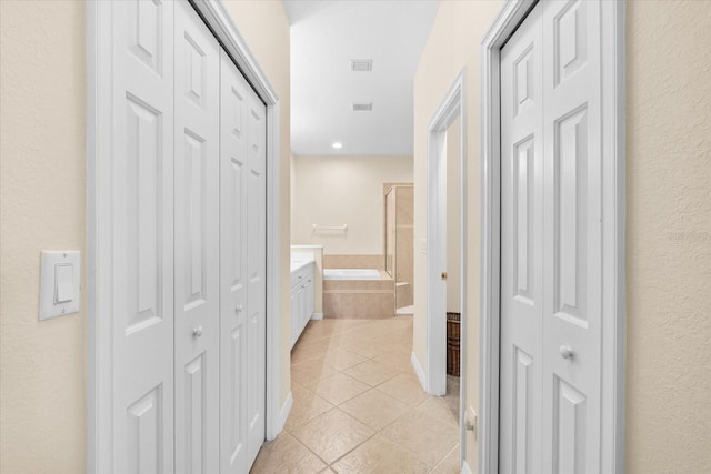 138 Tiziano Way N, Venice, FL 34275 - corridor with light tile patterned floors and a textured wall