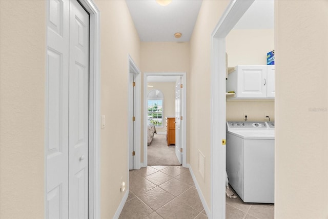 138 Tiziano Way N, Venice, FL 34275 - hallway with washer / clothes dryer, light tile patterned flooring, and baseboards