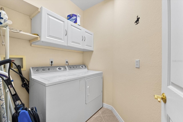 138 Tiziano Way N, Venice, FL 34275 - laundry area with cabinet space, washer and dryer, light tile patterned flooring, and baseboards