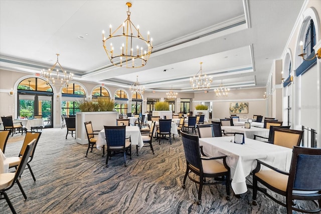138 Tiziano Way N, Venice, FL 34275 - dining room featuring a chandelier, a tray ceiling, crown molding, and carpet