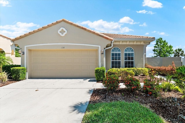 138 Tiziano Way N, Venice, FL 34275 - mediterranean / spanish-style house featuring stucco siding, driveway, an attached garage, and a tile roof