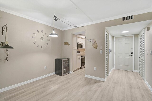 7211 Cloister Dr Unit 101, Sarasota, FL 34231 - unfurnished dining area with light wood-style floors, ornamental molding, and baseboards