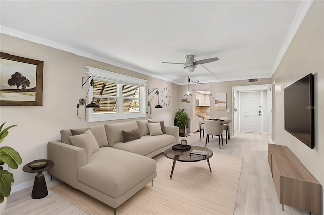 7211 Cloister Dr Unit 101, Sarasota, FL 34231 - living area featuring light wood-style flooring, ceiling fan, ornamental molding, and baseboards