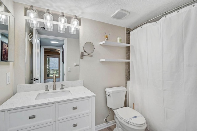 7211 Cloister Dr Unit 101, Sarasota, FL 34231 - full bath featuring toilet, vanity, a textured ceiling, and curtained shower