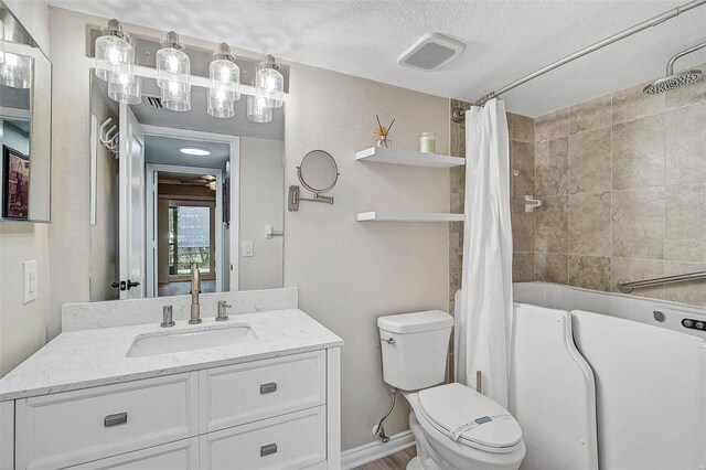 7211 Cloister Dr Unit 101, Sarasota, FL 34231 - full bathroom featuring vanity, shower / tub combo with curtain, toilet, and a textured ceiling