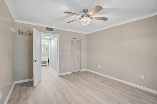 7211 Cloister Dr Unit 101, Sarasota, FL 34231 - unfurnished bedroom featuring light wood finished floors, ornamental molding, baseboards, a closet, and a ceiling fan