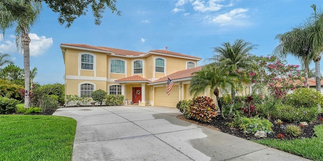 12520 Natureview Cir, Bradenton, FL 34212 - mediterranean / spanish home with an attached garage, stucco siding, concrete driveway, and a tiled roof