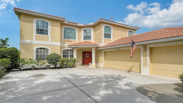 12520 Natureview Cir, Bradenton, FL 34212 - view of front of property featuring stucco siding, a garage, a tile roof, and concrete driveway