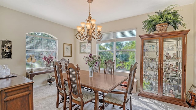 12520 Natureview Cir, Bradenton, FL 34212 - dining area with light colored carpet, a chandelier, and baseboards