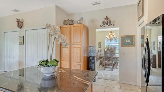 12520 Natureview Cir, Bradenton, FL 34212 - dining area with a chandelier, light carpet, light tile patterned flooring, and baseboards