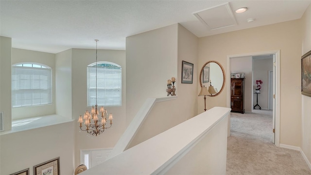 12520 Natureview Cir, Bradenton, FL 34212 - corridor with light carpet, healthy amount of natural light, a chandelier, and an upstairs landing