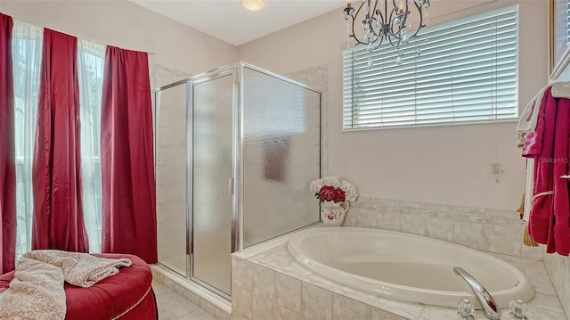 12520 Natureview Cir, Bradenton, FL 34212 - bathroom with a stall shower, a bath, a chandelier, and tile patterned flooring