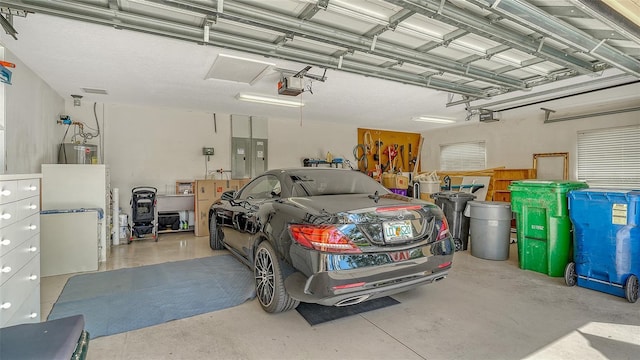 12520 Natureview Cir, Bradenton, FL 34212 - garage with electric panel, a garage door opener, and water heater