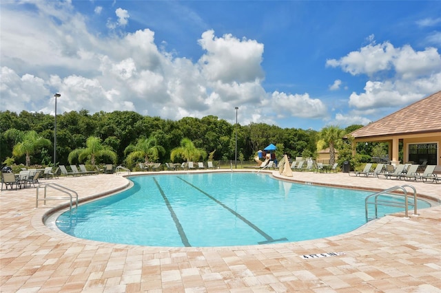 12520 Natureview Cir, Bradenton, FL 34212 - community pool featuring a patio area and view of wooded area