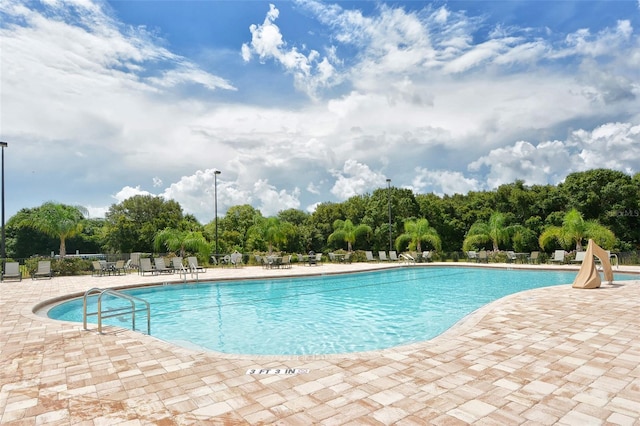 12520 Natureview Cir, Bradenton, FL 34212 - community pool featuring a patio area and view of scattered trees