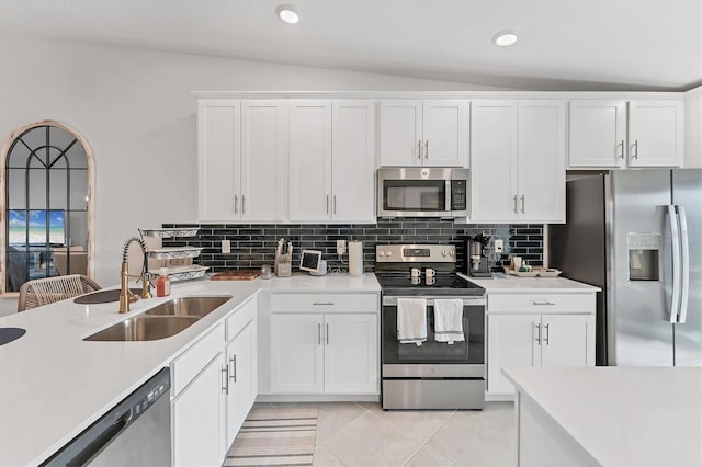 14257 Heritage Landing Blvd Unit 1122, Punta Gorda, FL 33955 - kitchen with appliances with stainless steel finishes, a sink, lofted ceiling, white cabinets, and light countertops