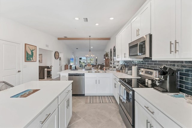 14257 Heritage Landing Blvd Unit 1122, Punta Gorda, FL 33955 - kitchen with stainless steel appliances, decorative backsplash, white cabinets, recessed lighting, and vaulted ceiling