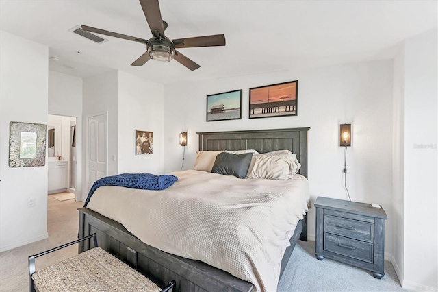 14257 Heritage Landing Blvd Unit 1122, Punta Gorda, FL 33955 - bedroom with light carpet, baseboards, ensuite bath, and ceiling fan