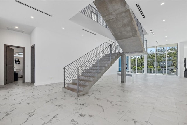 4035 Bay Shore Rd, Sarasota, FL 34234 - stairs featuring a wall of windows, a towering ceiling, recessed lighting, and marble finish flooring