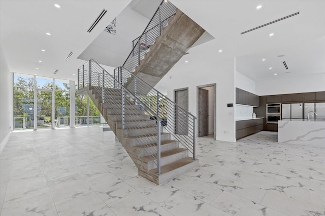 4035 Bay Shore Rd, Sarasota, FL 34234 - stairs with a high ceiling, recessed lighting, and a wall of windows