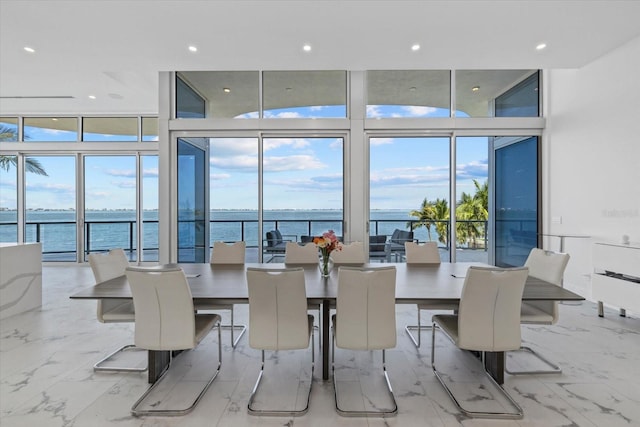 4035 Bay Shore Rd, Sarasota, FL 34234 - dining area featuring a water view, a wall of windows, plenty of natural light, recessed lighting, and marble finish floors