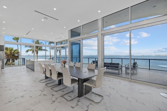 4035 Bay Shore Rd, Sarasota, FL 34234 - dining space with expansive windows, a water view, and light marble finish floors