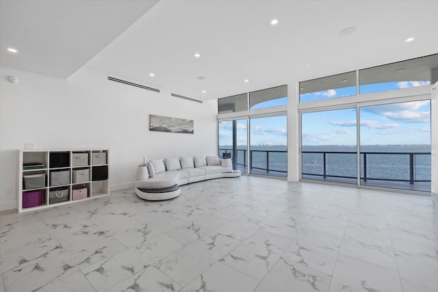 4035 Bay Shore Rd, Sarasota, FL 34234 - living room featuring healthy amount of natural light, a water view, floor to ceiling windows, recessed lighting, and marble finish flooring