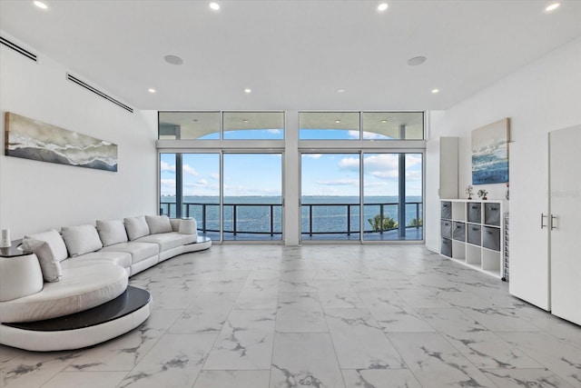 4035 Bay Shore Rd, Sarasota, FL 34234 - living area featuring a water view, expansive windows, recessed lighting, and marble finish floors