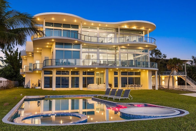 4035 Bay Shore Rd, Sarasota, FL 34234 - rear view of property featuring a balcony, a pool with connected hot tub, a patio area, and stucco siding