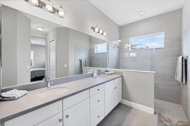 13549 Old Creek Ct, Parrish, FL 34219 - bathroom featuring double vanity, connected bathroom, a walk in shower, and tile patterned floors