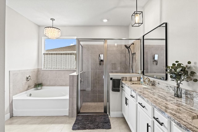 17547 Cantarina Cv, Bradenton, FL 34211 - bathroom featuring vanity, a bath, a stall shower, tile patterned floors, and a chandelier