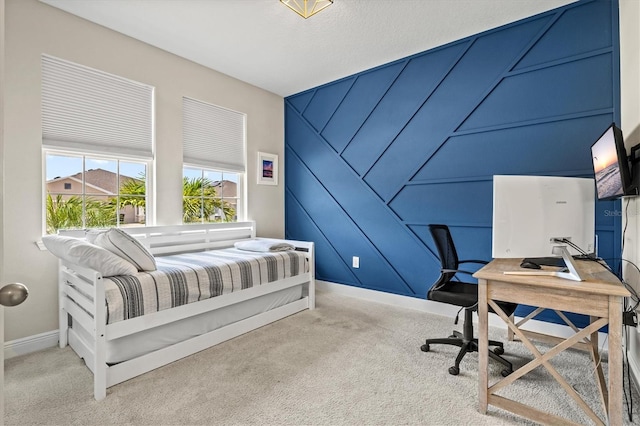 17547 Cantarina Cv, Bradenton, FL 34211 - carpeted bedroom with baseboards, a desk, a decorative wall, and an accent wall