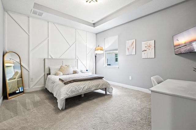 17547 Cantarina Cv, Bradenton, FL 34211 - bedroom with light carpet, baseboards, and a tray ceiling
